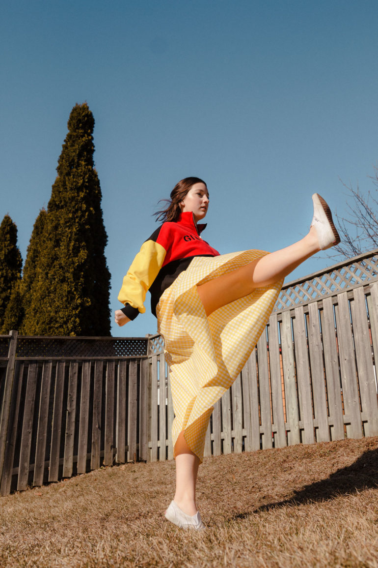 Emily Gilmore—Girl in yellow dress kicking in backyard