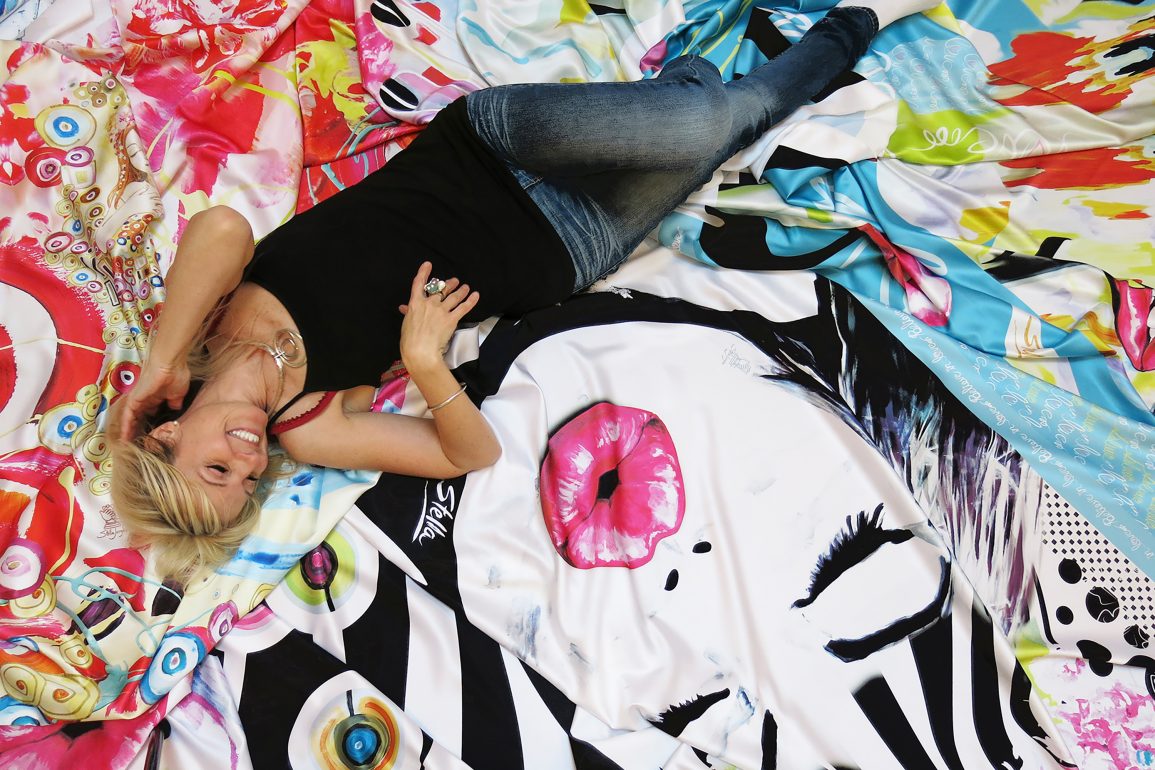 Stella Jurgen lays on art prints