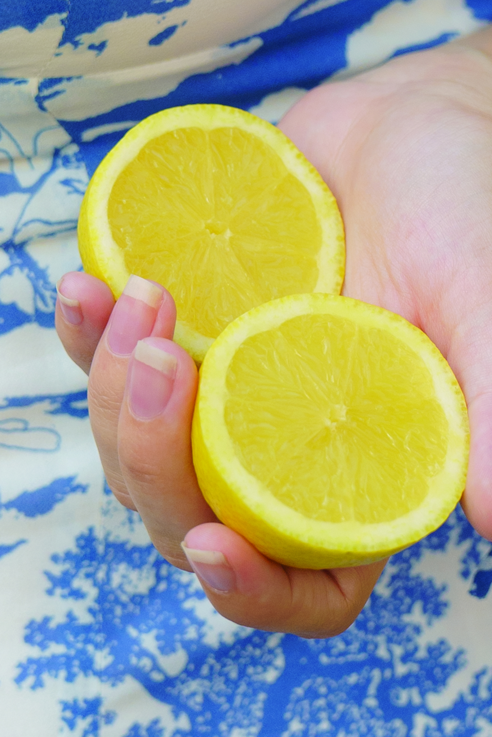 Two lemon halves in hand