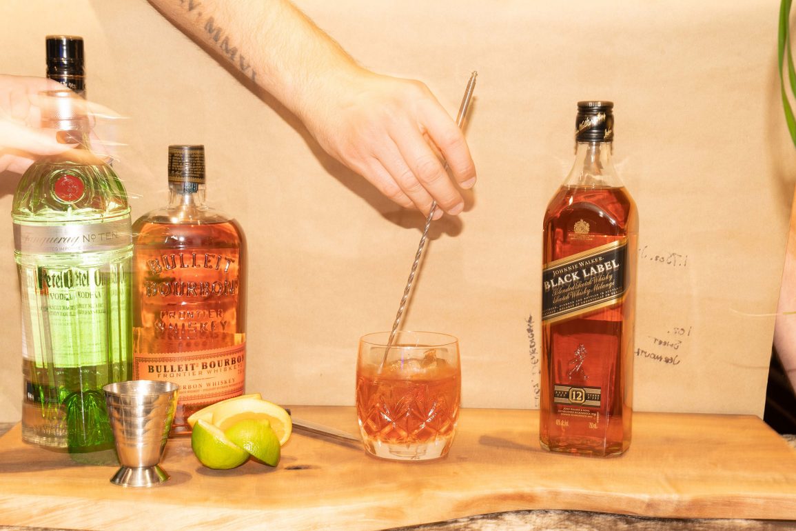 Mixing a cocktail with Johnnie Walker Black and Bulleit Bourbon