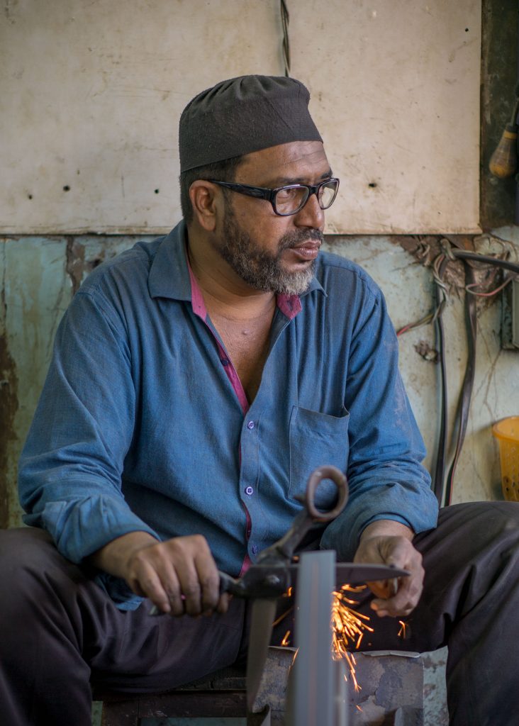 Man sharpening scissors in Mumbai