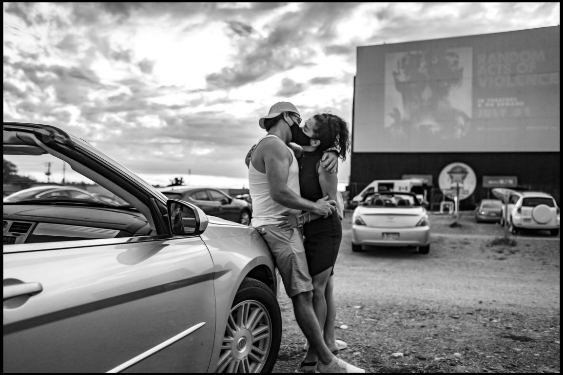 masked kissing at a drive-in Toronto by George Pimentel