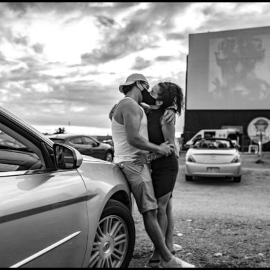 masked kissing at a drive-in Toronto by George Pimentel