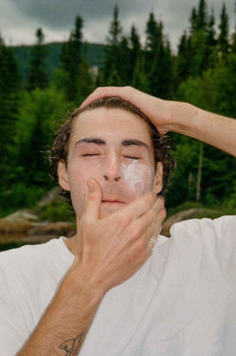 man applying cream to face